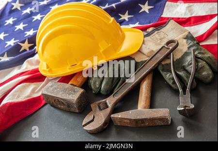 Labor Day concept. American flag and construction tools on dark background, above view. USA holiday celebration Stock Photo