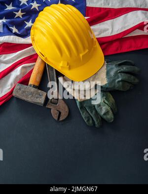 Labor Day concept. American flag and construction tools on dark background, above view. USA holiday celebration Stock Photo