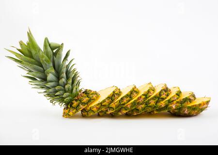 Pineapple with slices on a white background Stock Photo