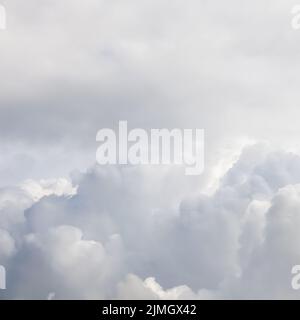 Cloudy sky background. Sunlight shining through white clouds. Stock Photo