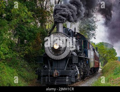 Close up a Antique Restored Steam Engine With Restored Coaches Approaching Stock Photo