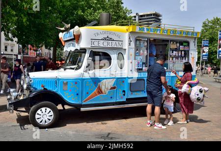 Classic Ice Cream Van In Pink With Disney Characters On It Waiting For classic-ice-cream-van-in-pink-with-disney-characters-on-it-waiting-for