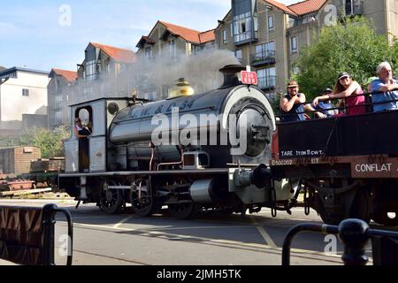 Bristol docks steam train running along quayside with visitors in waggon, UK Stock Photo