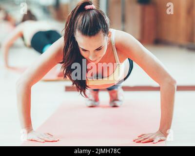 sport recreation fitness instructor push ups Stock Photo