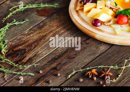 wine appetizers cheese fruit honey rustic table Stock Photo