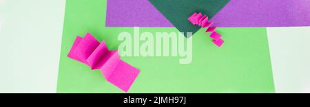 Banner with abstract background in green, pink and purple colors with 3D paper zig zag pattern . As a backdrop for advertising products, copy space. Stock Photo