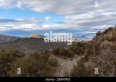 A hiking trail leading through the hills and canyons of the Tabernas desert in southern Spain Stock Photo