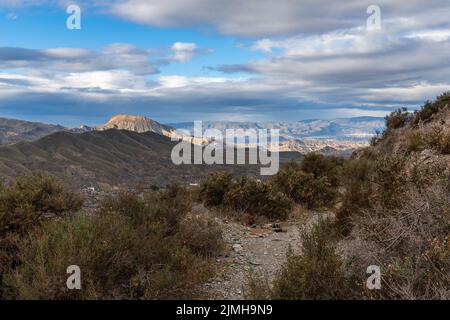 A hiking trail leading through the hills and canyons of the Tabernas desert in southern Spain Stock Photo