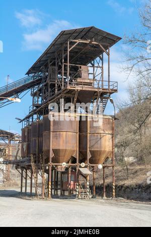 An old gravel quarry. Mining and quarrying equipment. Granite gravel stone open pit mining. Stock Photo