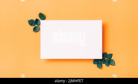 greeting card white paper leaves orange background
