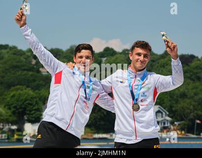 Dartmouth, Canada. August 6th, 2022. Gold Medalists and World Champions Pablo Martinez and Cayetano Garcia from Spain receiving their medal in the C2 Men 500m event. The 2022 ICF Canoe Sprint and Paracanoe World Championships takes place on Lake Banook in Dartmouth (Halifax). Credit: meanderingemu/Alamy Live News Stock Photo