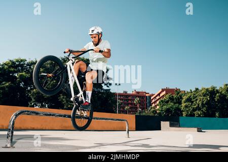 Teenage bmx rider performing tricks skatepark Stock Photo