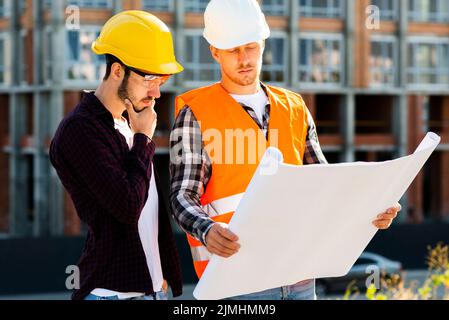 Medium shot architect engineer looking plans Stock Photo