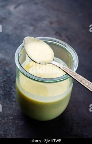 Traditional Bavarian vanilla sauce for apple strudel as close-up in a jar with text space Stock Photo