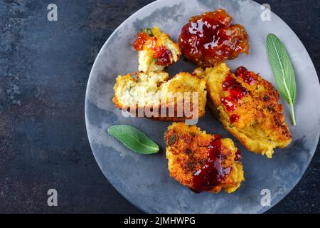 Traditional deep-fried gnocchi with spicy sauce served as top view on a modern design plate with copy space Stock Photo