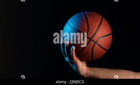 Front view basketball held by male hand Stock Photo