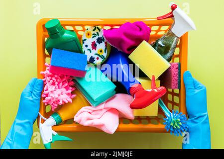 Close up person holding basket with cleaning products Stock Photo