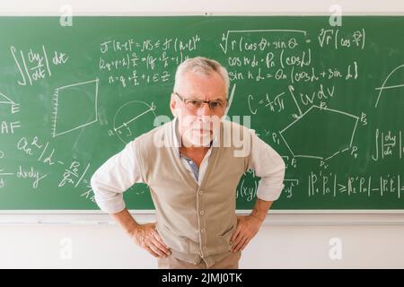 Serious aged professor lecture room looking camera Stock Photo