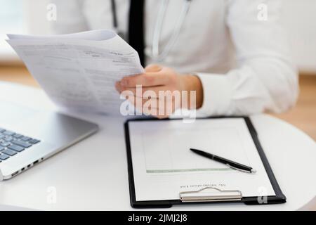 Close up doctor holding medical records Stock Photo