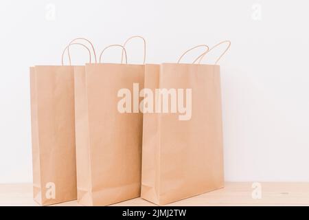 Close up paper shopping bags wooden desk Stock Photo