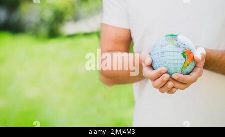 Mid section man holding globe hand Stock Photo