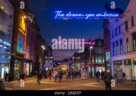 People, many wearing face masks due to the covid epidemic  walking and shopping on Briggate, one of the main pedestrian shopping Stock Photo