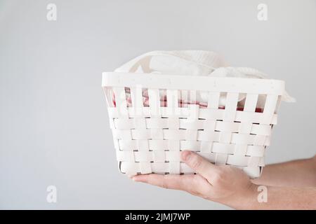 Sideways person holding laundry basket Stock Photo