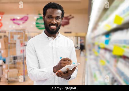 Man checking off items shopping list Stock Photo