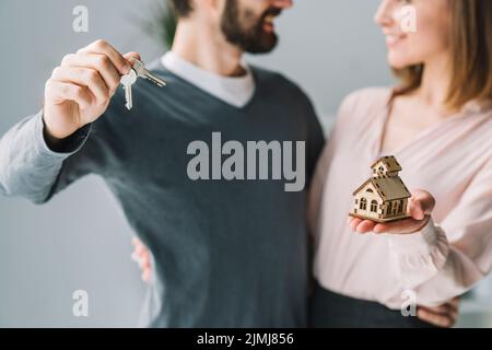 Crop couple with keys house Stock Photo
