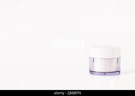 Glass cosmetic jar cream bottle with clipping path isolated on white background. Stock Photo