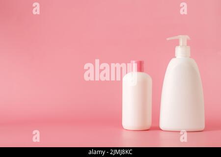 Cosmetics, Moisturizer, Bottle. Different cosmetic bottles. set of cosmetic products on pink background. Cosmetic package collection for cream, soups, Stock Photo