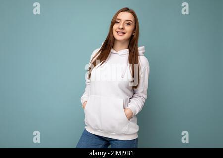 Photo of beautiful positive smiling adult woman wearing stylish clothes standing isolated on colorful background with copy space Stock Photo