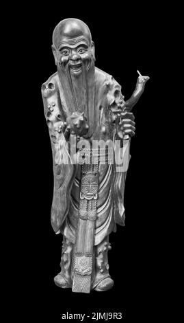 Wood statue of japan lucky god, God of prolonging life longevity Fukurokuju isolated on black background Stock Photo