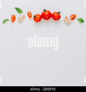 Whole slice cherry tomatoes garlic clove basil white background Stock Photo