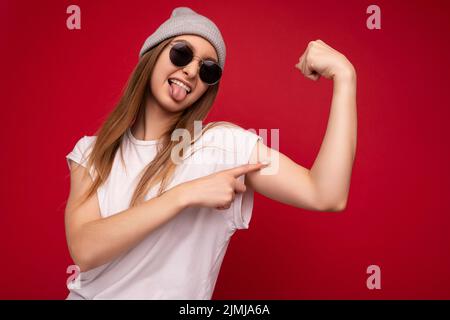 Portrait of young emotional positive happy attractive dark blonde woman with sincere emotions wearing casual white t-shirt with Stock Photo