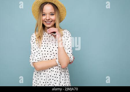 Young beautiful woman. Trendy woman in casual summer dress and straw hat. Positive female shows facial emotions. Funny model iso Stock Photo