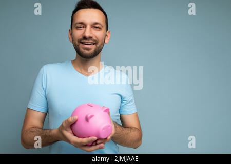 Photo of happy cute smiling young handsome brunet unshaven man with beard with sincere emotions wearing casual blue t-shirt isol Stock Photo