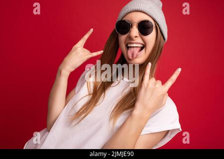 Portrait photo of young emotional positive happy funny laughing beautiful attractive dark blonde woman wearing casual white t-sh Stock Photo
