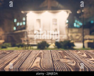 Empty wooden table front blurred house backdrop Stock Photo