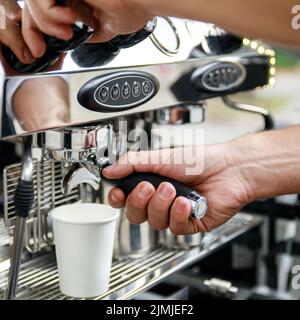 Barista making coffee using professional espresso machine Stock Photo