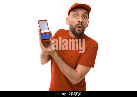 Surprised shocked courier demonstrates a discount card in a case holding it forward in his hands Stock Photo