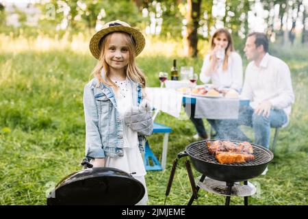 Family doing barbecue nature Stock Photo