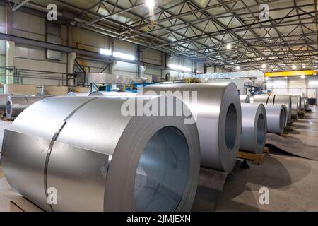 Metal tile for roof in metallic forming machine production line in factory. Cold rolled steel coils at the plant. Industrial con Stock Photo