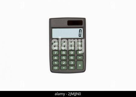 Calculator with big brown buttons and zero on the digital screen on a white background. Solar powered calculator. Electronic machine for math calculat Stock Photo