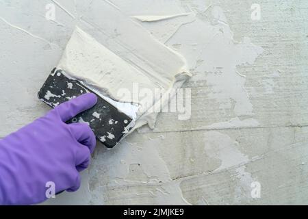 Texture of white plaster. Covering the concrete wall of the house. Rough surface. Repair and construction. Stock Photo