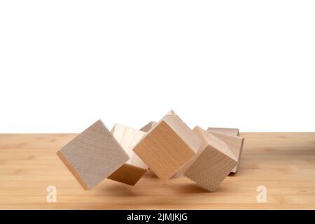 Wooden cubes roll on an inclined plane. Stock Photo