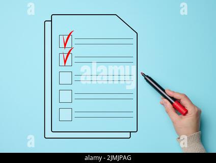 A female hand holds a red market and a document with cells for marking on a blue background. Voting concept, data validation, sh Stock Photo