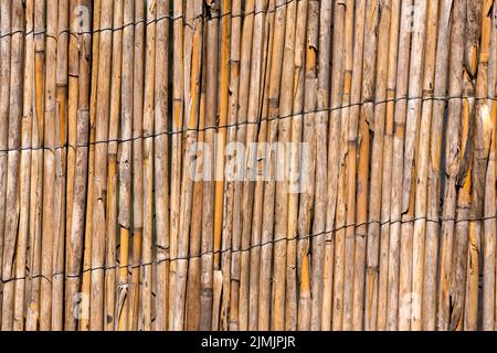 Old reed texture wallpaper background. Woven straw texture. Stock Photo