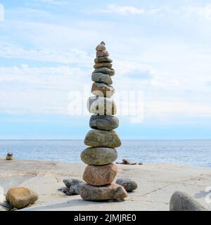 Stacked Rocks balancing, stacking with precision. Stone tower on the shore. Copy space. Stock Photo