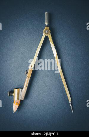 Old vintage pair of compasses on dark background Stock Photo